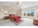 Bright primary bedroom offers large windows and a seating area with carpet flooring and a decorative light fixture at 5048 Rocky Mountain Dr, Castle Rock, CO 80109
