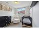 This Bedroom has a black crib, black dresser and a white chair at 5237 W 100Th Ct, Westminster, CO 80020