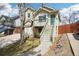 A two-story home with light green siding and a raised front deck at 5237 W 100Th Ct, Westminster, CO 80020