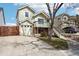 A two-story home with light green siding, a two-car garage, and a raised front deck at 5237 W 100Th Ct, Westminster, CO 80020