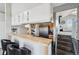 Bright kitchen featuring eat in counter, stainless steel appliances, and pantry at 5237 W 100Th Ct, Westminster, CO 80020