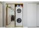 A bright laundry closet with stacked washer and dryer units and gold sliding door at 5237 W 100Th Ct, Westminster, CO 80020