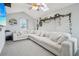 Comfortable living room with vaulted ceiling, skylight, large sectional, and decorative plants at 5237 W 100Th Ct, Westminster, CO 80020