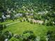 An aerial view showing the park with open green space, trees, a playground, and a walking path at 8490 E Davies Pl, Centennial, CO 80112