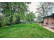The manicured lawn with mature landscaping creates a serene backyard at 8490 E Davies Pl, Centennial, CO 80112