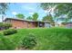 Large backyard featuring an abundance of green grass, landscaping and a covered patio at 8490 E Davies Pl, Centennial, CO 80112