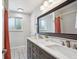 Stylish bathroom featuring a double vanity, large mirror, and modern fixtures and a shower/tub combo at 8490 E Davies Pl, Centennial, CO 80112