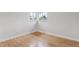 Sunlit bedroom with hardwood floors, a window, and white trim at 8490 E Davies Pl, Centennial, CO 80112