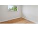 Light-filled bedroom with beautiful hardwood flooring and a bright window at 8490 E Davies Pl, Centennial, CO 80112