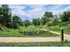A walking path and wooden fence can be seen in a photo of the lovely community park at 8490 E Davies Pl, Centennial, CO 80112