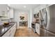 Contemporary kitchen with stainless steel appliances, white cabinets, and subway tile at 8490 E Davies Pl, Centennial, CO 80112