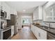 Bright kitchen featuring stainless steel appliances, white cabinetry, and stylish subway tile backsplash at 8490 E Davies Pl, Centennial, CO 80112