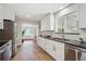 Modern kitchen featuring white cabinetry, stainless steel appliances, and sleek countertops at 8490 E Davies Pl, Centennial, CO 80112