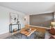 Open-concept living room with hardwood floors, neutral walls, and modern accents at 8490 E Davies Pl, Centennial, CO 80112