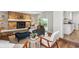 Cozy living room boasts a stone fireplace, built-in shelving, and access to the backyard at 8490 E Davies Pl, Centennial, CO 80112