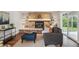 Comfortable living room with a stone fireplace, built-in shelves, and neutral decor at 8490 E Davies Pl, Centennial, CO 80112