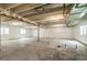 Spacious unfinished basement with concrete flooring and white wrapped walls, offering potential for customization at 13342 E 110Th Way, Commerce City, CO 80022