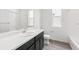 Bright bathroom featuring a single sink vanity, toilet, and shower and tub combo at 13342 E 110Th Way, Commerce City, CO 80022
