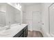 Bright bathroom featuring double sinks with modern fixtures and a shower with glass doors at 13342 E 110Th Way, Commerce City, CO 80022