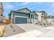 Charming home featuring a two-car garage, covered porch, and well-maintained landscaping at 13342 E 110Th Way, Commerce City, CO 80022