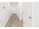 Bright and spacious hallway with light wood flooring and white doors leading to various rooms at 13342 E 110Th Way, Commerce City, CO 80022