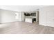 Open-concept living room featuring light wood floors, abundant natural light, and a view into the kitchen at 13342 E 110Th Way, Commerce City, CO 80022
