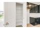 Walk-in pantry with wire shelving, adjacent to the kitchen with dark cabinets at 13342 E 110Th Way, Commerce City, CO 80022