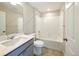 Bathroom with a combination shower and bathtub, a single sink, and stylish fixtures at 21854 E 9Th Pl, Aurora, CO 80018