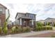 Charming two-story home featuring a stone facade, red door, and attractive landscaping at 21854 E 9Th Pl, Aurora, CO 80018