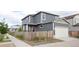 Charming home with neutral siding, complemented by a well-kept yard and a two-car garage at 21854 E 9Th Pl, Aurora, CO 80018