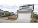 Attached garage showcasing a white door, stone accents, and gray siding at 21854 E 9Th Pl, Aurora, CO 80018