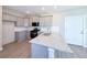 Modern kitchen featuring gray cabinets, granite countertops, stainless steel appliances, and wood-look flooring at 21854 E 9Th Pl, Aurora, CO 80018