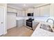 Modern kitchen featuring stainless steel appliances, granite countertops, and stylish cabinets at 21854 E 9Th Pl, Aurora, CO 80018