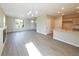 Open floor plan with gray floors connecting a modern living room with a fireplace to a kitchen with granite countertops at 21854 E 9Th Pl, Aurora, CO 80018