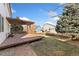 Deck with pergola, landscaping, and a view of the neighboring homes at 447 Woodson Dr, Erie, CO 80516