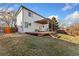 Home's exterior showcasing a deck, pergola, and steps leading to the backyard at 447 Woodson Dr, Erie, CO 80516