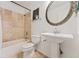 Bathroom with pedestal sink, toilet and shower/tub combo at 447 Woodson Dr, Erie, CO 80516