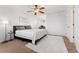 Main bedroom with king bed, ceiling fan and workspace at 447 Woodson Dr, Erie, CO 80516