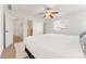 Main bedroom with king bed, access to bathroom and neutral decor at 447 Woodson Dr, Erie, CO 80516