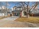 Two-story home with a gray garage door and landscaping at 447 Woodson Dr, Erie, CO 80516