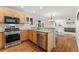 Bright kitchen with stainless steel appliances and wood flooring at 447 Woodson Dr, Erie, CO 80516