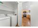 Convenient laundry room with washer, dryer, and shelving at 447 Woodson Dr, Erie, CO 80516