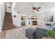 Open living room with a view into the kitchen and staircase at 447 Woodson Dr, Erie, CO 80516