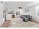 Living room with fireplace, seating area, and access to other rooms at 447 Woodson Dr, Erie, CO 80516