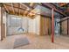 Unfinished basement area with exposed utilities, a small window, and flooring at 447 Woodson Dr, Erie, CO 80516