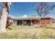 Expansive backyard featuring a covered patio area and well-maintained lawn at 6737 Lee St, Arvada, CO 80004