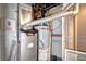 Basement utility area with modern furnace and hot water heater at 6737 Lee St, Arvada, CO 80004