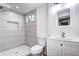 Modern bathroom with a glass shower, tiled walls, and a sleek vanity at 6737 Lee St, Arvada, CO 80004