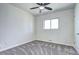 Relaxing bedroom with a ceiling fan, large window, and modern carpet at 6737 Lee St, Arvada, CO 80004