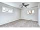 Bright bedroom with two windows, a ceiling fan, and neutral carpet at 6737 Lee St, Arvada, CO 80004